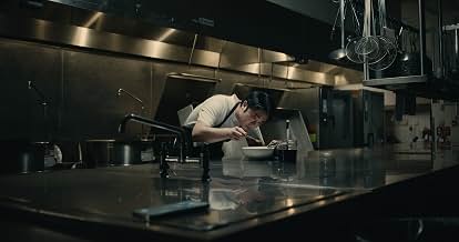 Person eating at a stainless steel counter in a kitchen in Peanut
