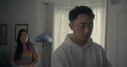 Person in a white hoodie in the foreground, with another person near a window in Peanut