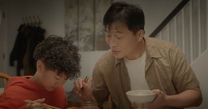 Two people eating with bowls and chopsticks at a dining table in Peanut